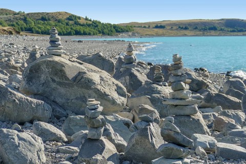 Coastal scenery with stone piles seen around Lake Pukaki at the South Island of New Zealand