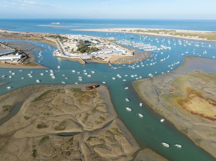 Network of channels and streams at low tide and the fishing village of Sancti Petri at the Atlantic