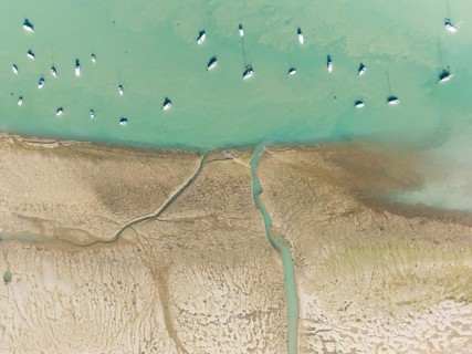 Sports and fishing boats at low tide near the fishing village of Sancti Petri. In the marshland of