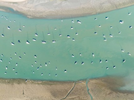 Sports and fishing boats at low tide near the fishing village of Sancti Petri. In the marshland of