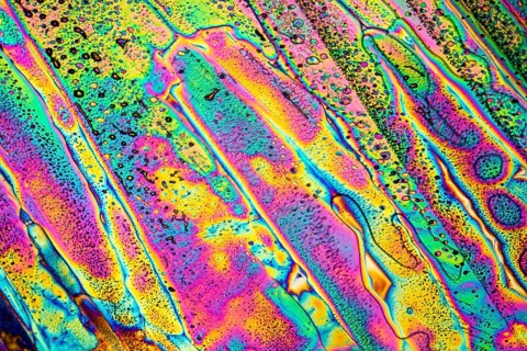 Colorful microscopic shot of Sodium acetate micro crystals in polarized light