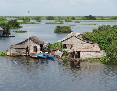 Waterside scenery with rural houses at the Tonle Sap, a river in Cambodia