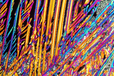 Colorful microscopic shot of Sodium nitrate microcrystals in polarized light