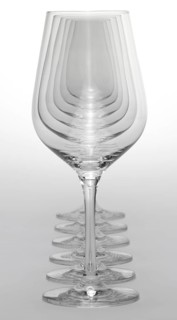 Some clean and empty wine glasses standing in a row in light grey back