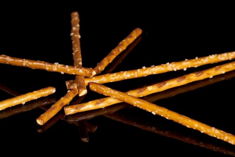 Closeup of some salt sticks on dark striped glossy ground