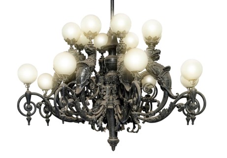 Illuminated historic dusty chandelier in black back