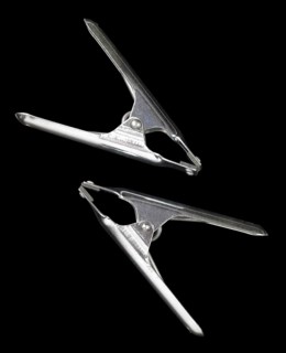 Studio photography of two metal clamps isolated on black