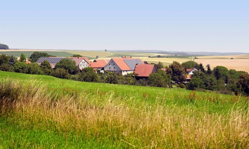 Small rural village in Southern Germany at summer time in agricultural ambiance