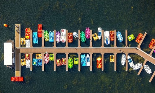 Aerial view, colourful pedal boats at a jetty on the Unterbacher See at the campsite north,