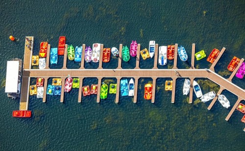 Aerial view, colourful pedal boats at a jetty on the Unterbacher See at the campsite north,