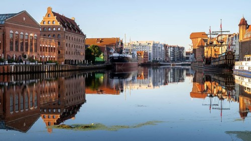Waterfront promenade with reflection at sunrise in the Old Town, Motlawa River, Gdansk, Gdansk,