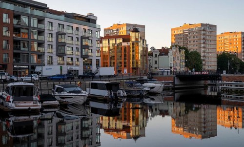 Waterfront promenade with reflection at sunrise in the old town, boat harbour, Motlawa River,