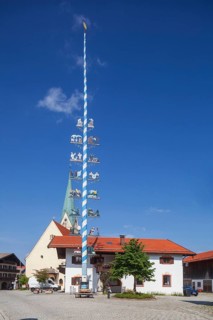 Parish Church of the Assumption of the Virgin Mary with maypole and town hall on the village