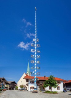 Parish Church of the Assumption of the Virgin Mary with maypole and town hall on the village