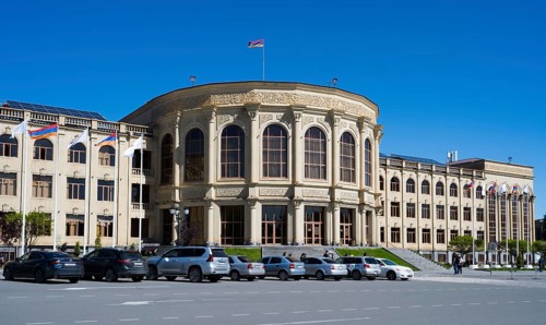 A large historic building with classical architecture under a clear sky, Gyumri City Hall, Gyumri,