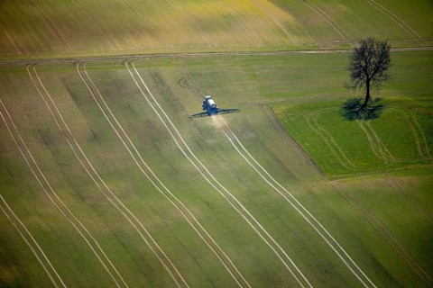 Aerial view, slurry tractor on a field during slurry spraying, emission, in Lichtenfels in Hesse.