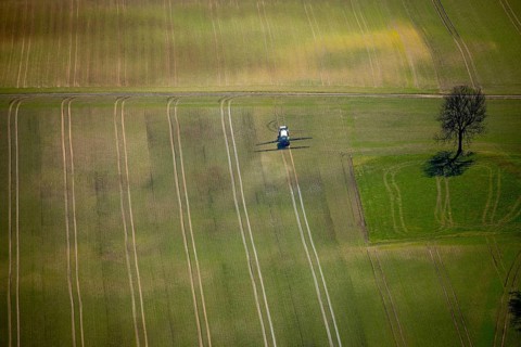 Aerial view, slurry tractor on a field during slurry spraying, emission, in Lichtenfels in Hesse.