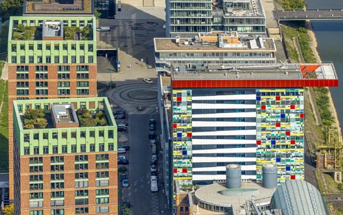 Aerial view, Colorium Hotel Innside Düsseldorf harbour and artistic coloured glass panel facade,
