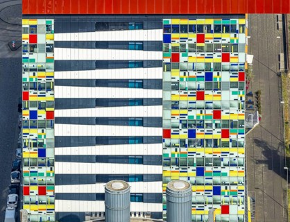 Aerial view, Colorium Hotel Innside Düsseldorf harbour and artistic coloured glass panel facade,