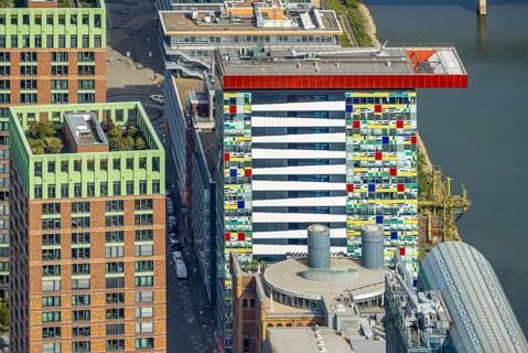 Aerial view, Colorium Hotel Innside Düsseldorf harbour and artistic coloured glass panel facade,