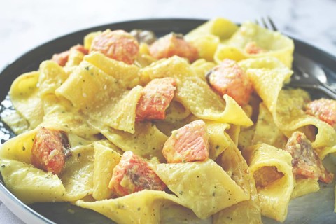Papardelle pasta, in creamy sauce with salmon, natural light, lifestyle, homemade, on a gray