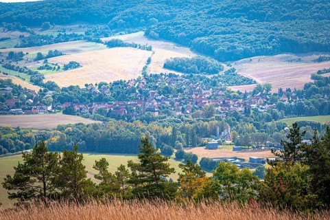 Small village of Kunitz in a hilly landscape with fields and forests, Jena, Thuringia, Germany