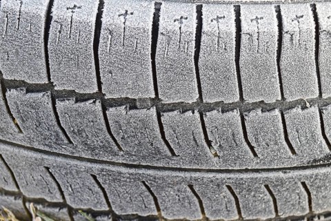 Hoarfrost on a rubber tire wheel. Morning frost