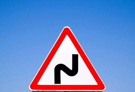 Road sign dangerous turn. Warning a sign. Krasnodar, Russia