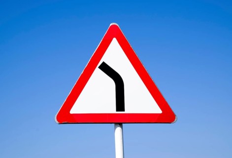 Road sign dangerous turn. Warning a sign. Krasnodar, Russia