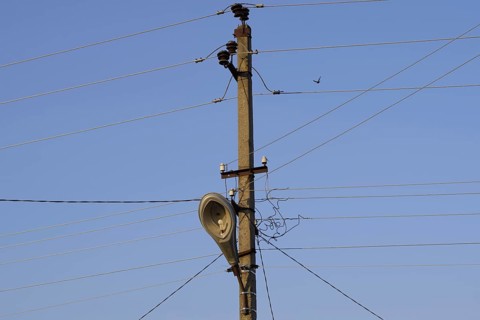 Power line post with a street lighting lamp. Krasnodar, Russia