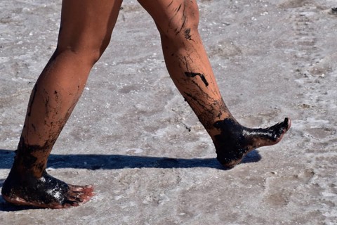 Legs walking girl on the dry bottom of a salt lake. Taman, Krasnodar Krai, Russia