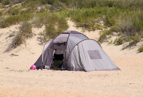 Tourist tent on the sand. Parking of tourists on the sandy beach. Golubitskaya, Russia