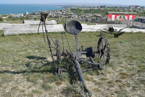 The exhibit of the old plow on the grass. Taman, Krasnodar Krai, Russia