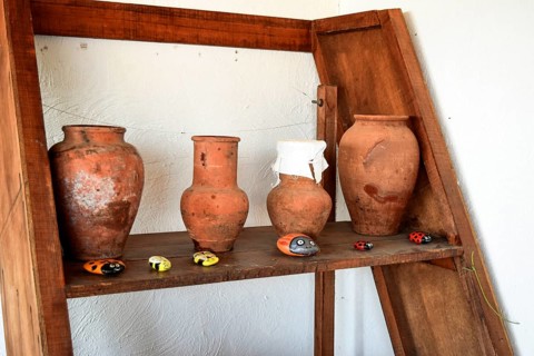Shelves with standing on their utensils of porcelain and earthenware. Taman, Krasnodar Krai, Russia