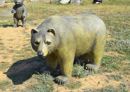 Mannequin dummy bear on the lawn. Taman, Krasnodar Krai, Russia