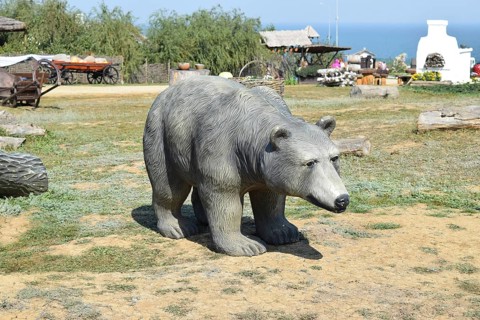 Mannequin dummy bear on the lawn. Taman, Krasnodar Krai, Russia