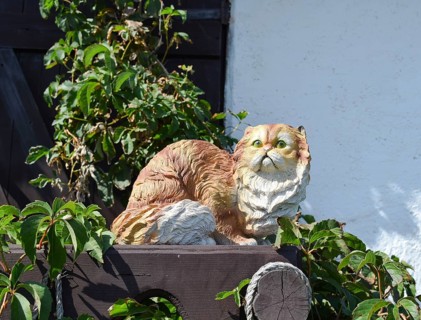 Toy cat on the fence. Taman, Krasnodar Krai, Russia