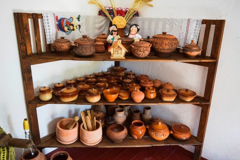 Shelves with standing on their utensils of porcelain and earthenware. Taman, Krasnodar Krai, Russia