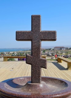 Orthodox cross made of granite near the chapel. Taman, Krasnodar Krai, Russia