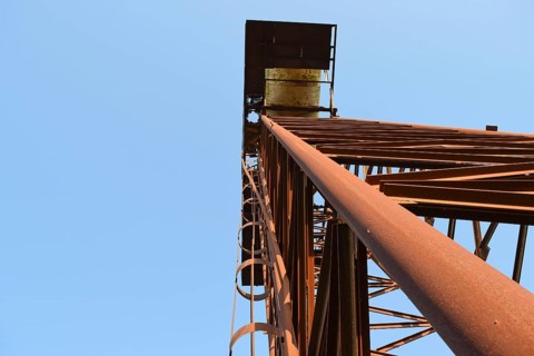 The old rusty water tower tilted. Atyrau, Kazakhstan