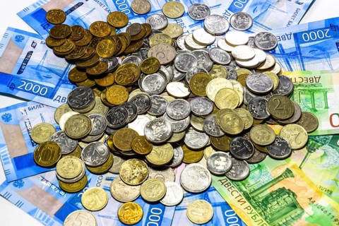A handful of coins on new Russian banknotes in denominations of 2000 and 200 rubles. Krasnodar,