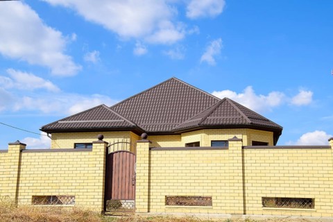 Decorative metal on the roof of a brick house. Atyrau, Kazakhstan