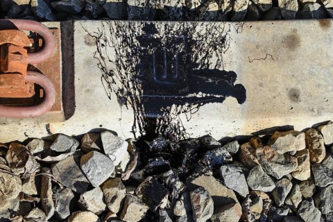 Black Resin shed on the railroad ties. Atyrau, Kazakhstan