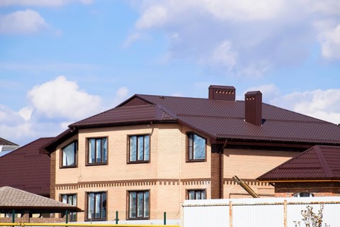 Decorative metal on the roof of a brick house. Atyrau, Kazakhstan