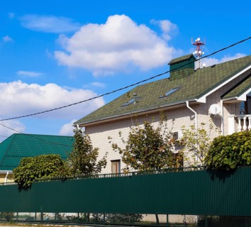 Asphalt shingle. Decorative bitumen shingles on the roof of a brick house. Atyrau, Kazakhstan