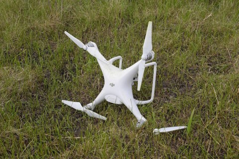 The crashed drone. Dirty and in the juice of the grass is a quadrocopter. Atyrau, Kazakhstan