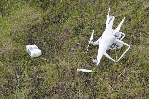 The crashed drone. Dirty and in the juice of the grass is a quadrocopter. Atyrau, Kazakhstan