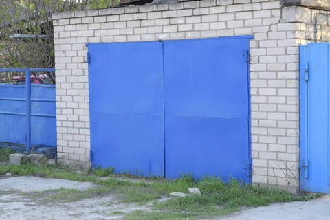 Garage with blue iron gates. Atyrau, Kazakhstan
