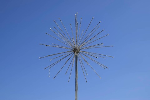 Street lamp in the form of fireworks. Garlands on a steel frame in the shape of a ball fireworks.