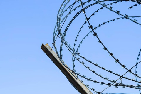 Barbed wire on the fence. Atyrau, Kazakhstan